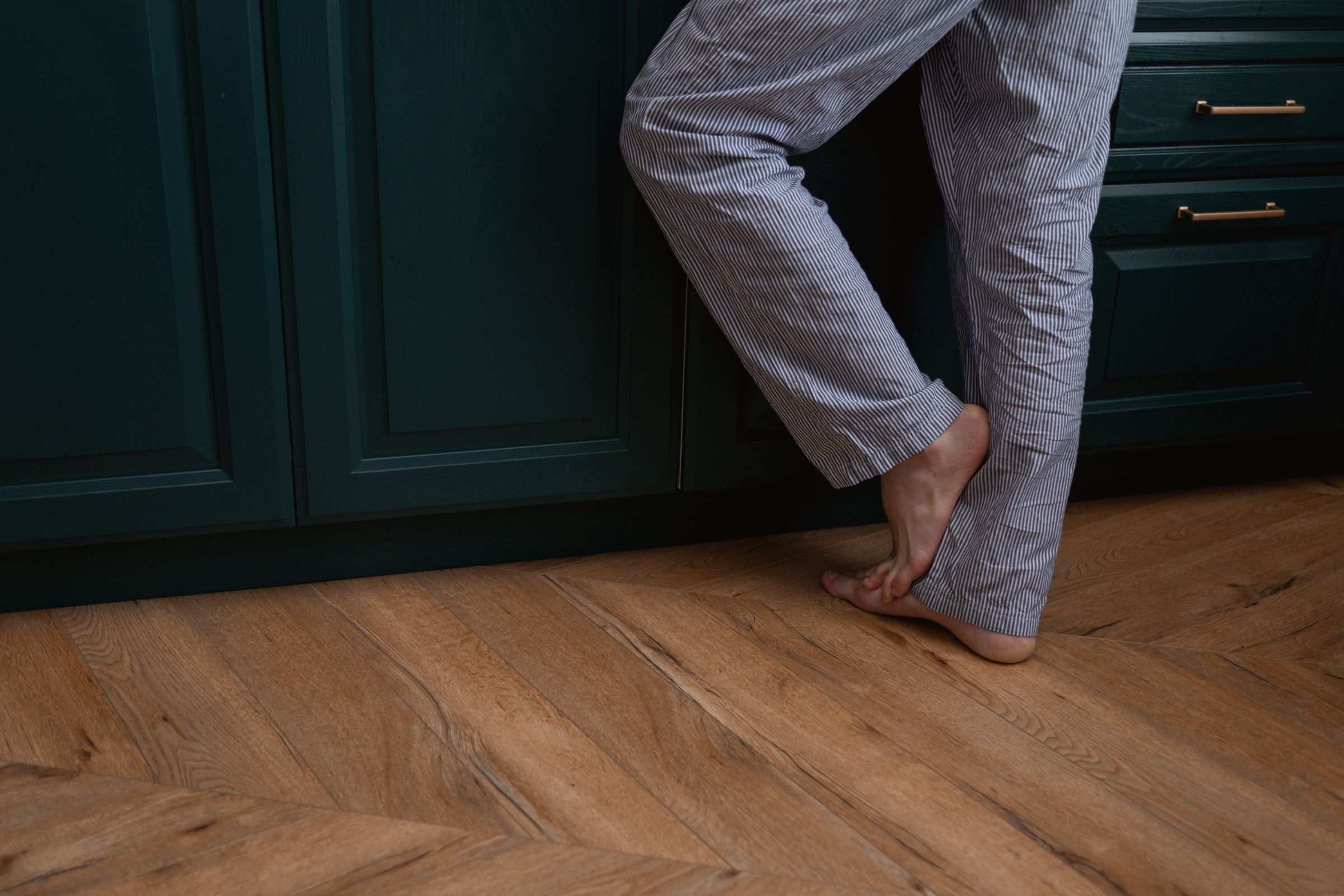 Tiptoe on oak floor in a cozy kitchen