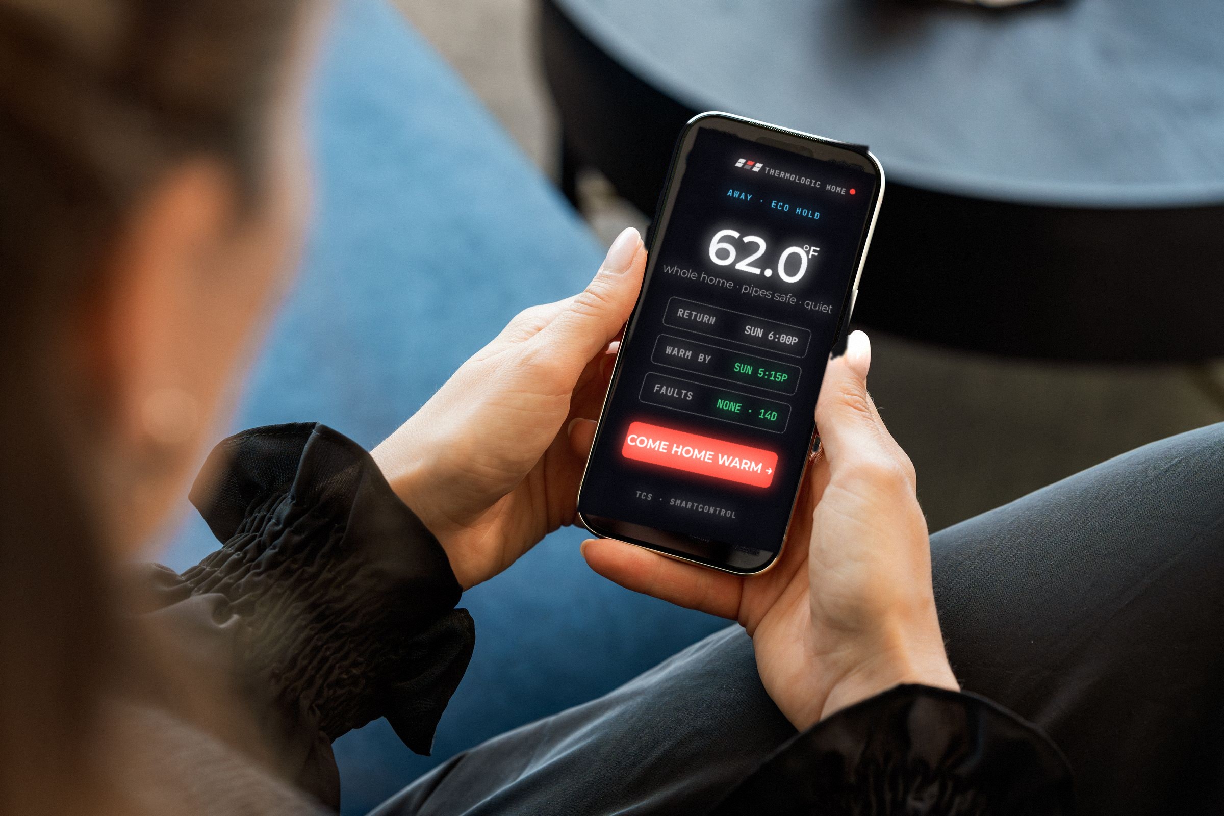 ThermoLogic Home app in hand, over the shoulder