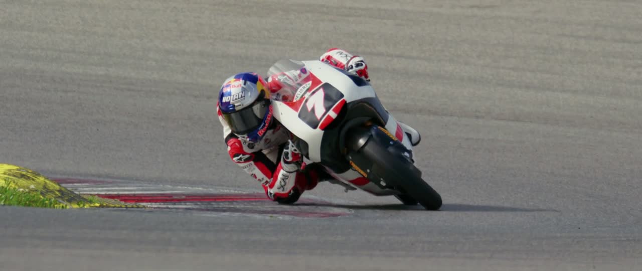 Motorcycle leaning through a corner toward the camera